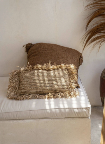 Handmade raffia pillow, in outdoor coastal setting