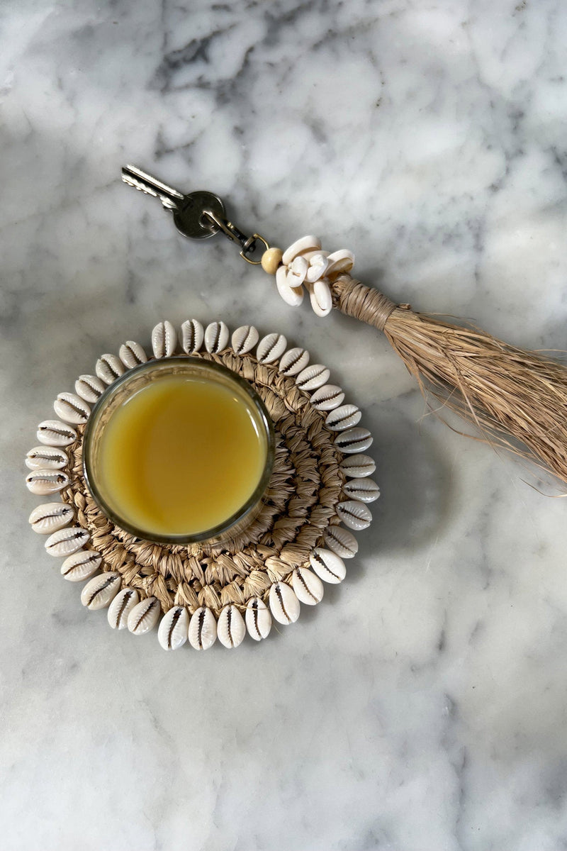 The Raffia Cowrie Shell Keychain in raffia — handmade luxury keychain curated by Laiyahome — view 2