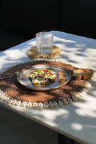 The Colonial Shell Placemat - Natural Brown – rattan placemat in natural brown – product view 2